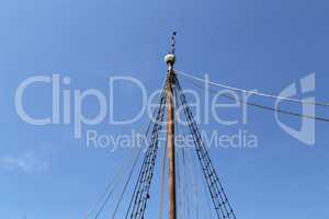 The mast of a sailing vessel against the blue sky