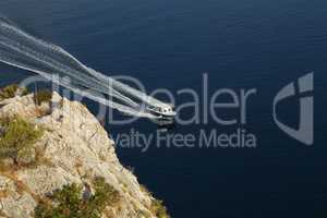 Fishing boat with motor glides on the surface of the lake