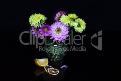 Vase with dahlias and cosmos on a black background