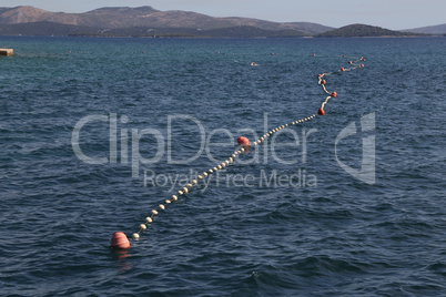 rope with buoys to fence off a safe swimming area on the beach