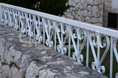 Decorative fence of stones and metal structures