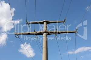 Power transmission masts against a blue sky