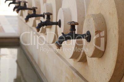 A close up of a row of water taps