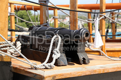 Old medieval cannon on the deck of a pirate ship