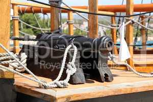 Old medieval cannon on the deck of a pirate ship