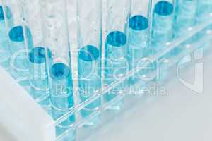 Abstract of Scientific Test Tubes Containing Blue Chemical In Ra