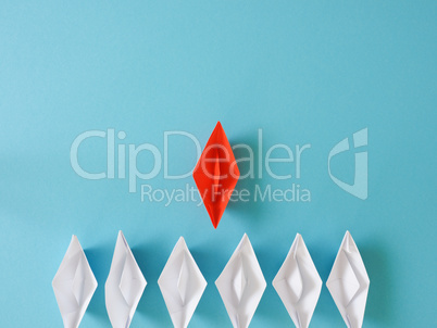 Leadership or Teamwork business concept with paper boat on a blu