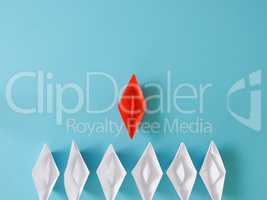 Leadership or Teamwork business concept with paper boat on a blu