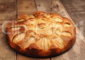 Delicious homemade organic apple pie on a rustic kitchen table