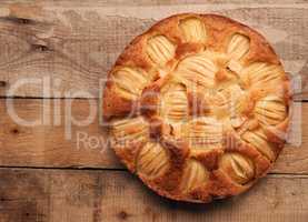 Delicious homemade organic apple pie on a rustic kitchen table,