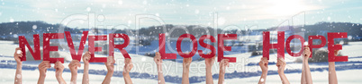 People Hands Holding Word Never Lose Hope, Snowy Winter Background
