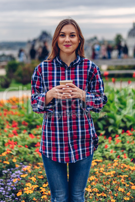 Beautiful young woman holding coffee cup