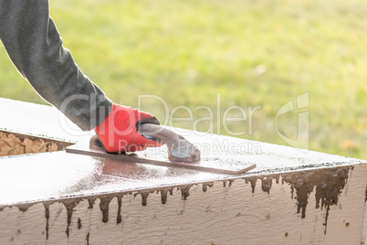 Construction Worker Using Wood Trowel On Wet Cement Forming Copi