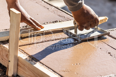 Construction Worker Using Hand Groover On Wet Cement Forming Cop