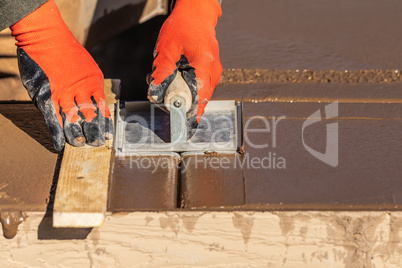 Construction Worker Using Hand Groover On Wet Cement Forming Cop