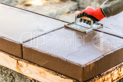 Construction Worker Using Hand Groover On Wet Cement Forming Cop