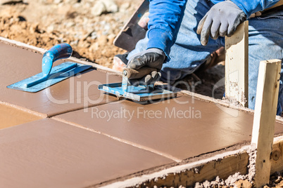 Construction Worker Using Hand Groover On Wet Cement Forming Cop