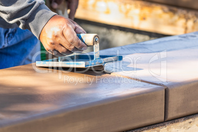 Construction Worker Using Hand Groover On Wet Cement Forming Cop