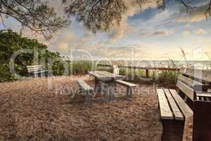 Wood bench overlooks White sand path leading toward Delnor Wiggi