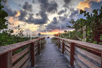 Lone man on a Boardwalk leading toward Delnor-Wiggins State Park