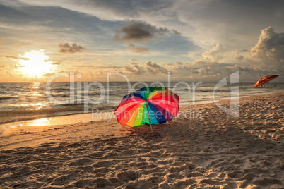 Rainbow umbrella on White sand at Delnor Wiggins State Park at s