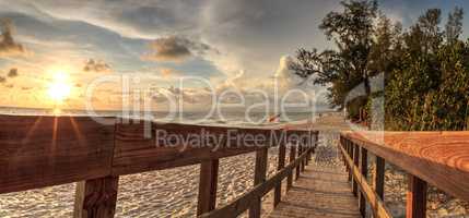 Boardwalk leading toward Delnor-Wiggins State Park at sunset