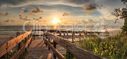 Boardwalk leading toward Delnor-Wiggins State Park at sunset