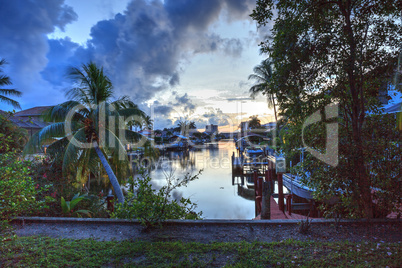 Boat lift in a waterway at sunset in Naples