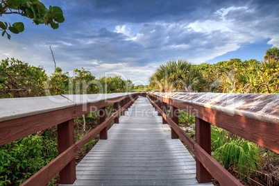 Boardwalk leads down to the white sand of Barefoot Beach