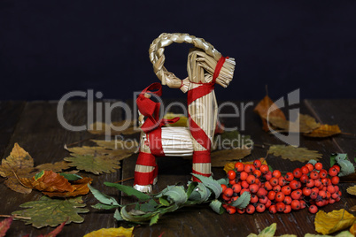 Autumn composition of straw horse and leaves