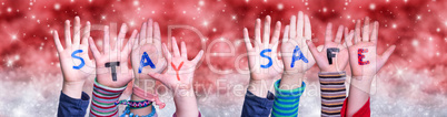 Children Hands Building Word Stay Safe, Red Christmas Background