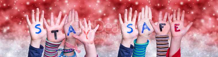 Children Hands Building Word Stay Safe, Red Christmas Background