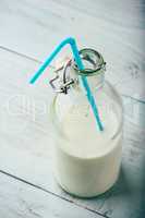 Milk in bottle with blue straw
