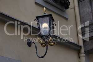 Old street lamps illuminate the way for passersby