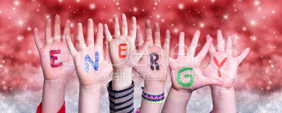 Children Hands Building Word Energy, Red Christmas Background