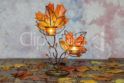 Autumn composition with yellow leaves and candles