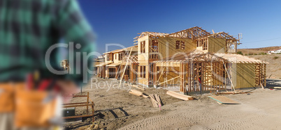 Contractor In Front New House Wood Framing at Construction Site