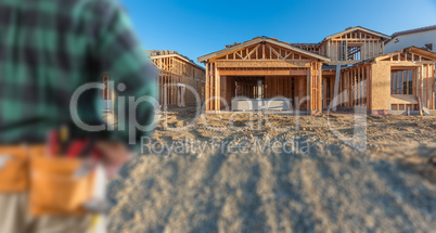 Contractor In Front New House Wood Framing at Construction Site