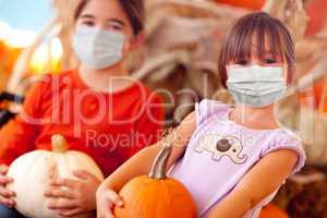 Cute Little Girls Holding Their Pumpkins At A Pumpkin Patch Wear