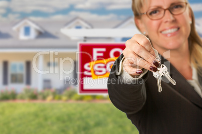 Real Estate Agent Handing Over New House Keys with Sold Sign Beh