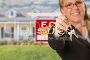 Real Estate Agent Handing Over New House Keys with Sold Sign Beh