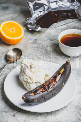 Grilled banana with dark chocolate and vanilla ice cream.
