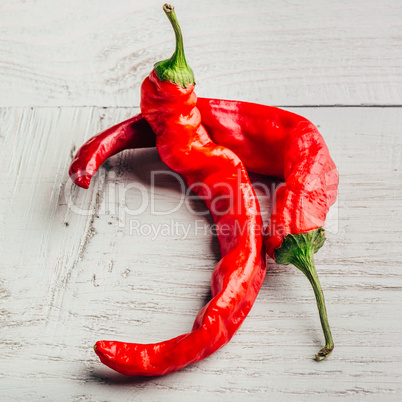 Red chili peppers on wooden background.