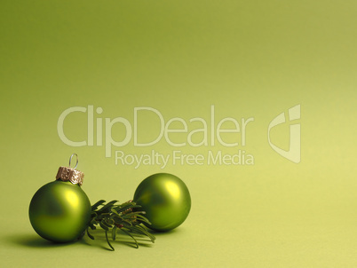 Green vintage Christmas baubles on a green background