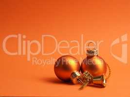 Orange vintage Christmas baubles on an orange background