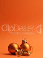 Orange vintage Christmas baubles on an orange background