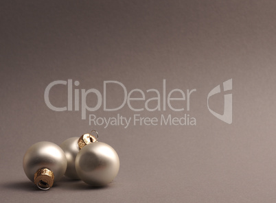 Silver vintage Christmas baubles on a grey background