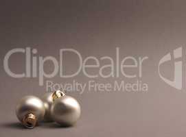 Silver vintage Christmas baubles on a grey background