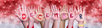 Children Hands Building Word December, Red Christmas Background
