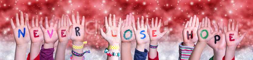 Children Hands Building Word Never Lose Hope, Red Christmas Background